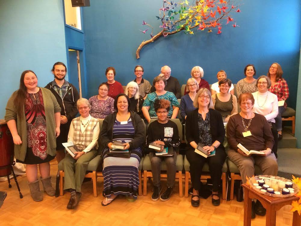 Group of 20 congregation members sitting in chairs and smiling