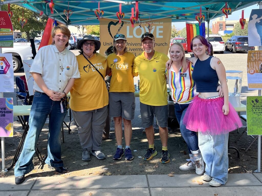 A group of six congregation members with yellow "love" shirts on at the Livermore Pride Fest